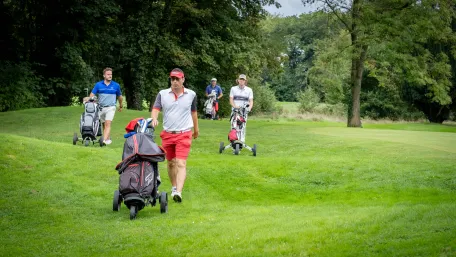 joueur-de-golf-qui-marche-avec-leurs-sacs-sur-le-terrain-de-golf