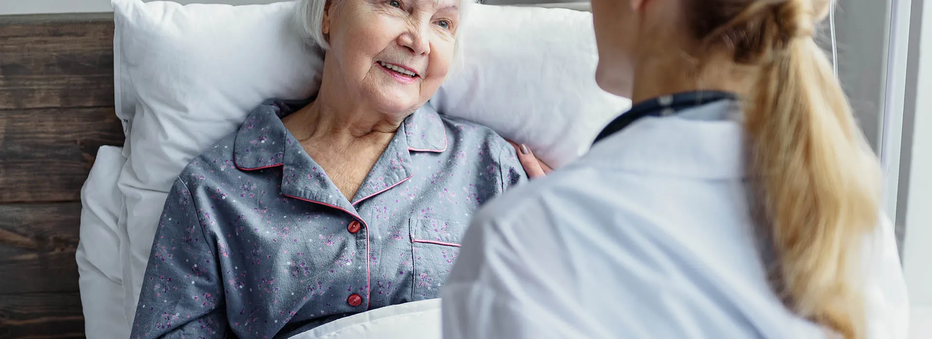 woman in bed doctor attending 